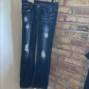 Dark flared distressed jeans